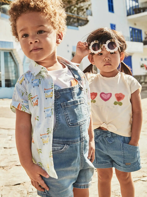 Baby boy modelling the Mayoral denim dungarees.