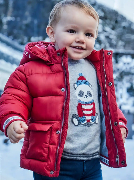 Smiling baby boy modelling the Mayoral embroidered jumper.