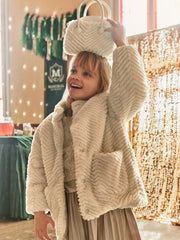 Girl modelling the Mayoral faux fur coat.
