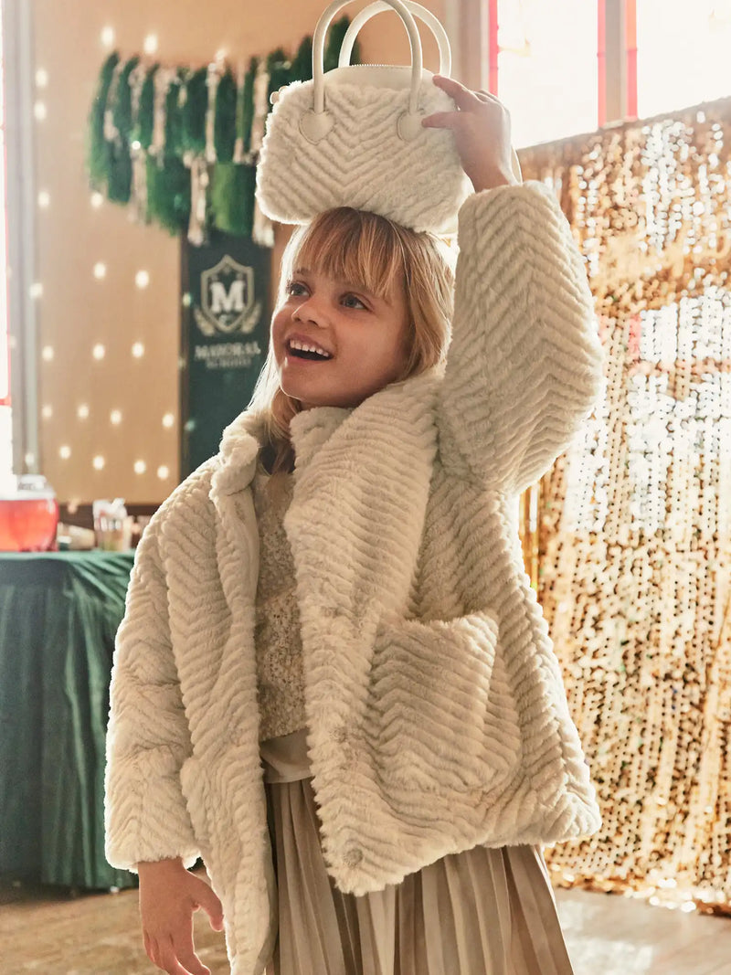 Girl modelling the Mayoral faux fur coat.
