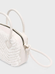 Back of the Mayoral beige faux fur handbag.