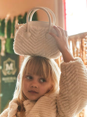 Girl modelling the Mayoral faux fur handbag.