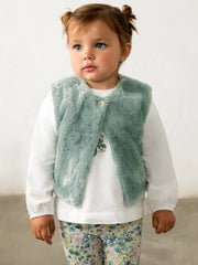Baby girl in green faux fur vest & leggings set by Mayoral.