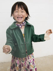 Smiling Girl modelling the Mayoral faux leather jacket.