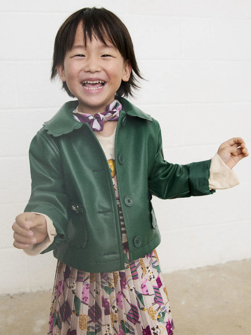 Smiling Girl modelling the Mayoral faux leather jacket.