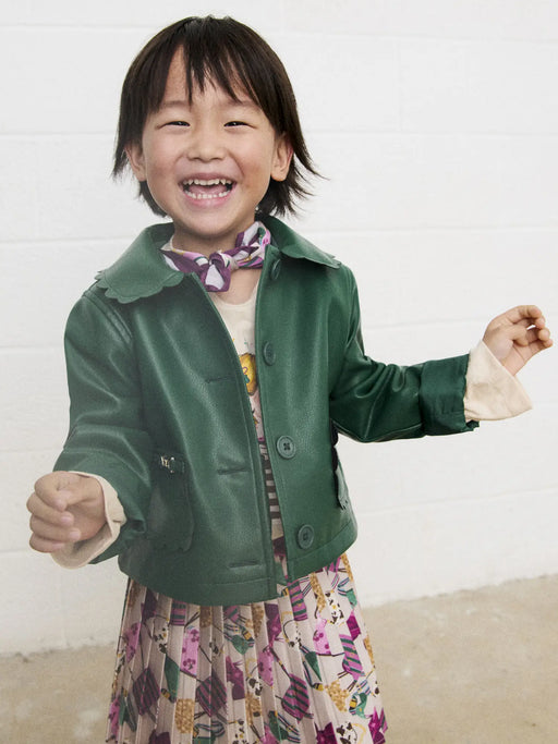 Smiling Girl modelling the Mayoral faux leather jacket.