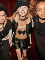 Girl wearing the Mayoral faux leather shorts.