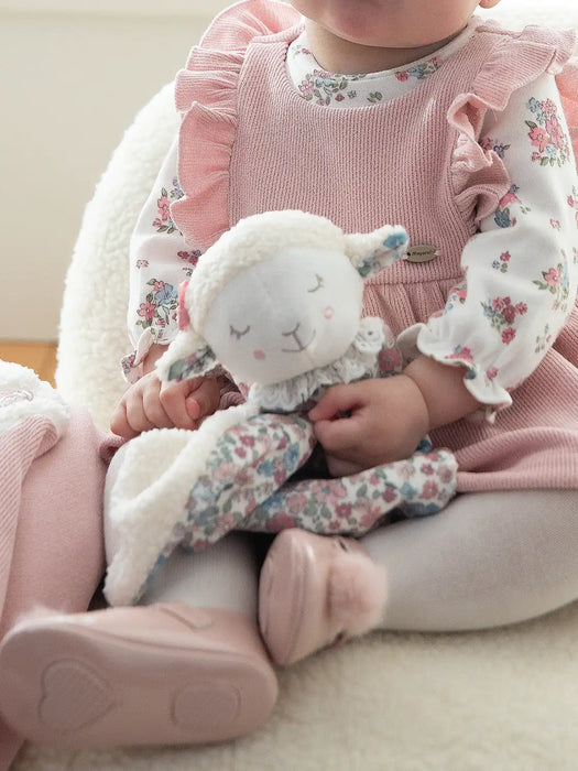 Baby girl holding the Mayoral fleece comforter.