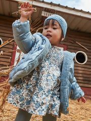 Baby girl modelling the Mayoral smocked dress.