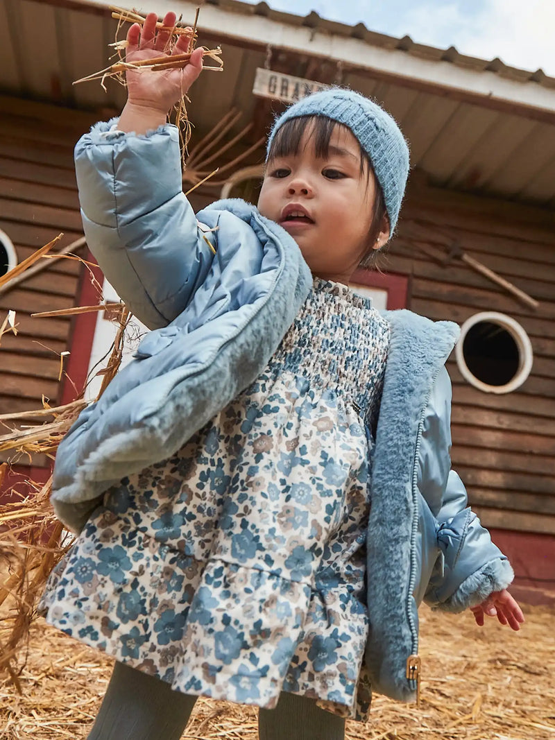 Baby girl modelling the Mayoral smocked dress.
