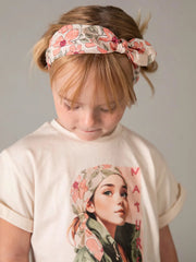 Girl wearing the Mayoral floral print shorts set.