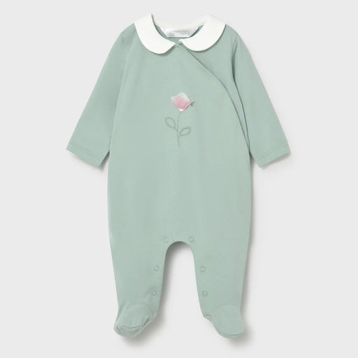 Green babygrow with pink flower on the front.