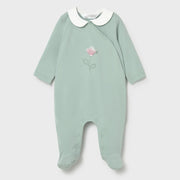 Green babygrow with pink flower on the front.