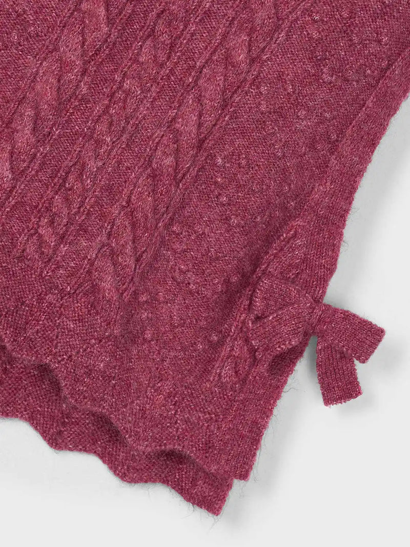 Girl's knitted vest with scalloped hem.