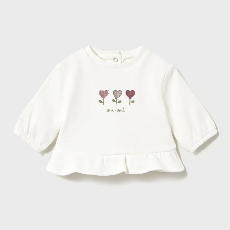 Baby girl's white t-shirt with embroidered flowers on the front.