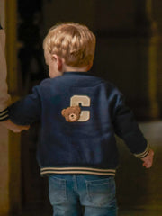 Baby boy in blue varsity jacket by Mayoral.