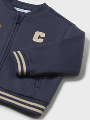 Closer look at the Mayoral varsity jacket showing detail of the striped trim.