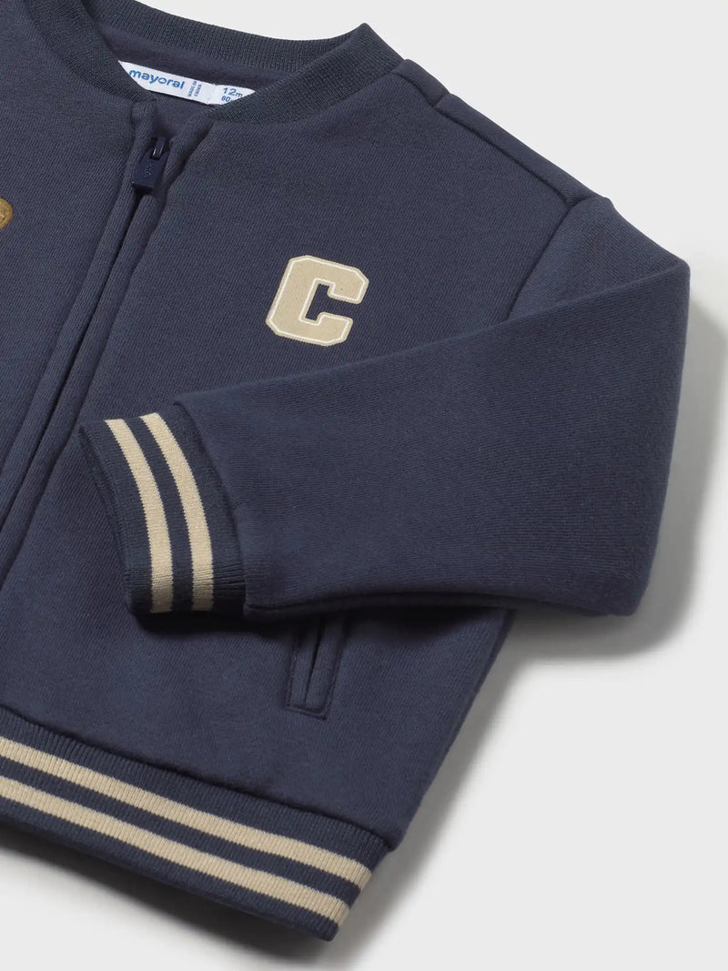 Closer look at the Mayoral varsity jacket showing detail of the striped trim.