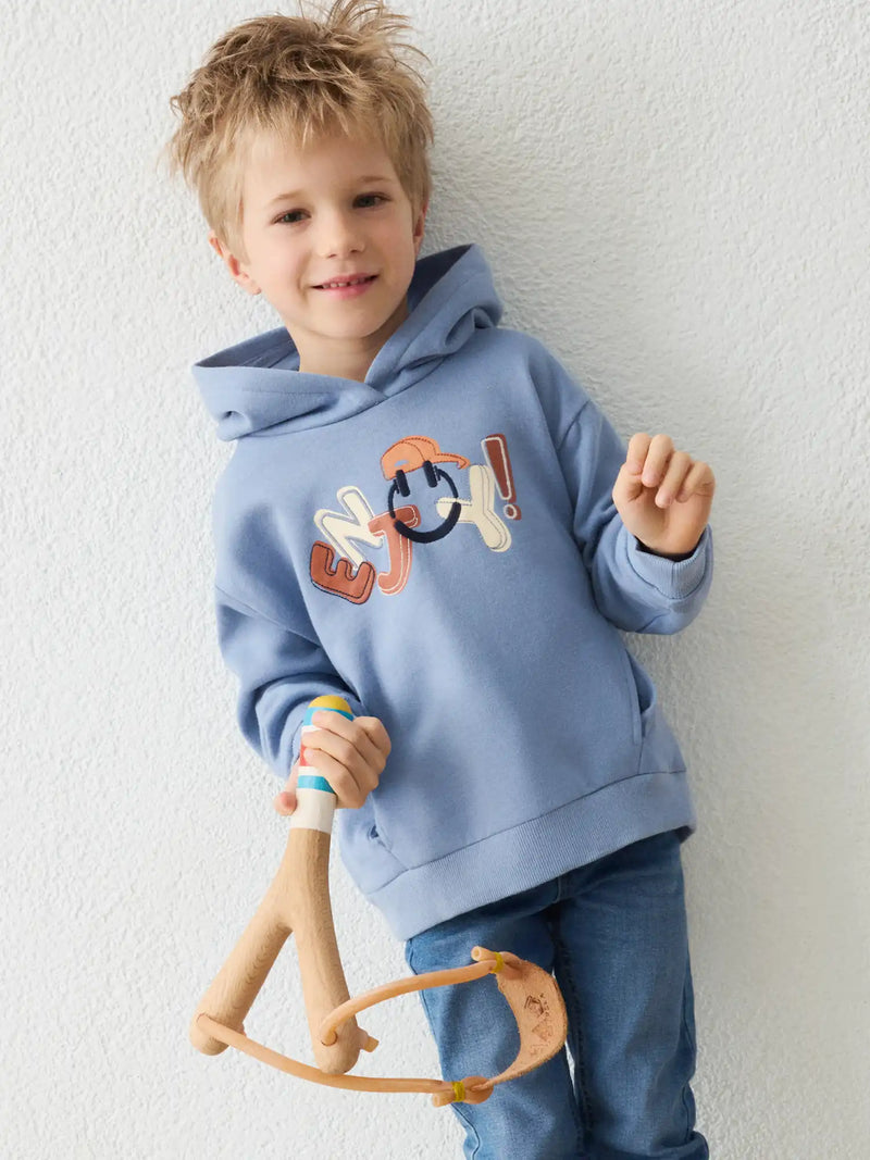 Boy modelling the Mayoral hoodie.