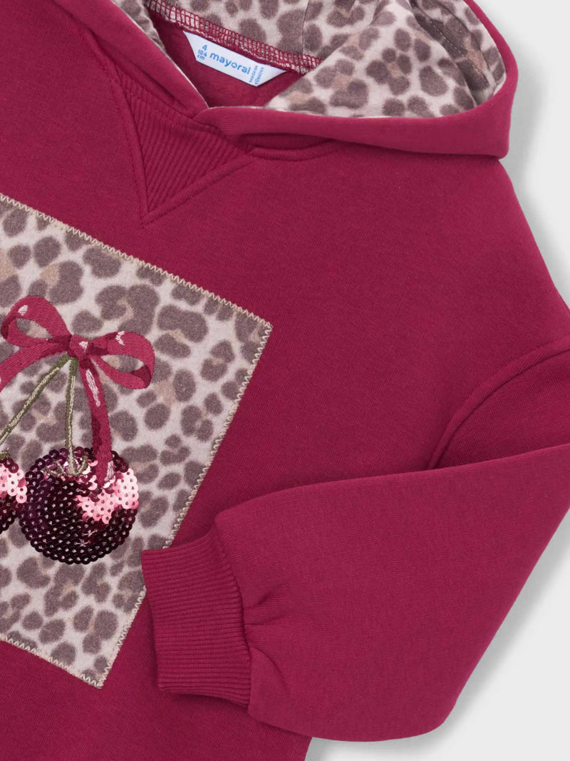 Closer look at the Mayoral hoodie dress showing detail of the sequin cherry design on the front.