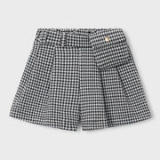 Girl's black and white houndstooth shorts.