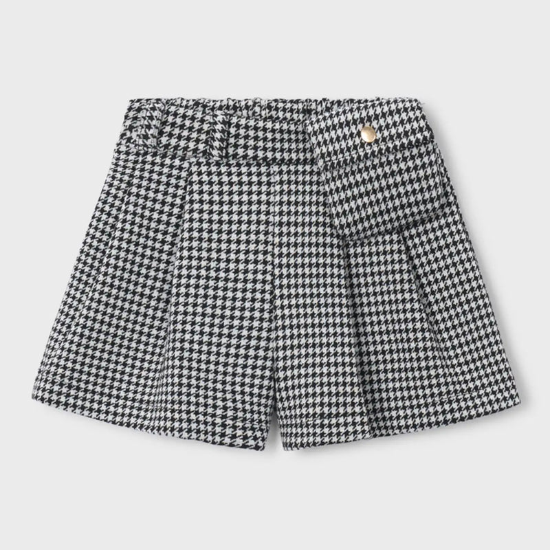 Girl's black and white houndstooth shorts.