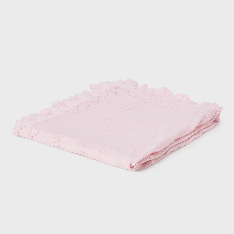 Closer view of the Mayoral knitted blanket.