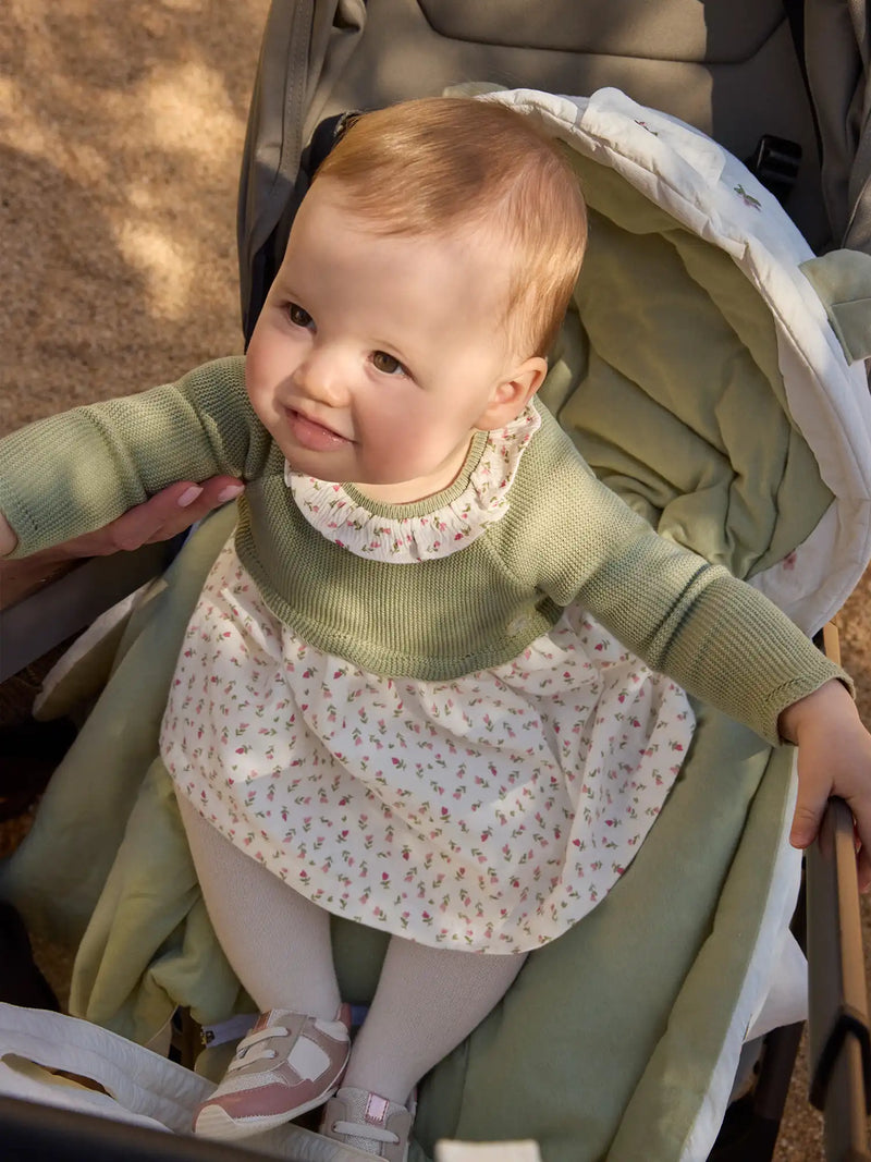 Baby girl wearing the Mayoral knitted dress.