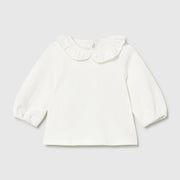 Baby girl's long sleeve white top.
