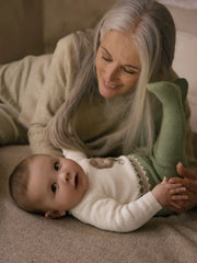 Baby boy in green knitted leg warmer set by Mayoral.