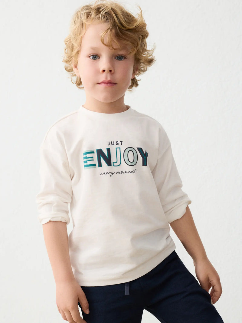Boy in cream long sleeve t-shirt by Mayoral.
