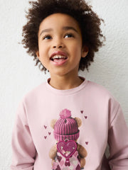 Girl in pink long sleeve t-shirt by Mayoral.
