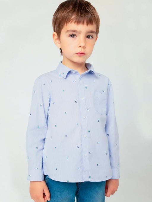 Boy modelling the Mayoral microprint shirt.