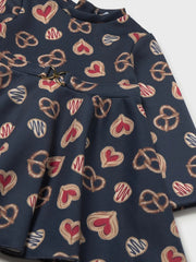 Mayoral navy dress with all over print of pretzels and sweet pastries.