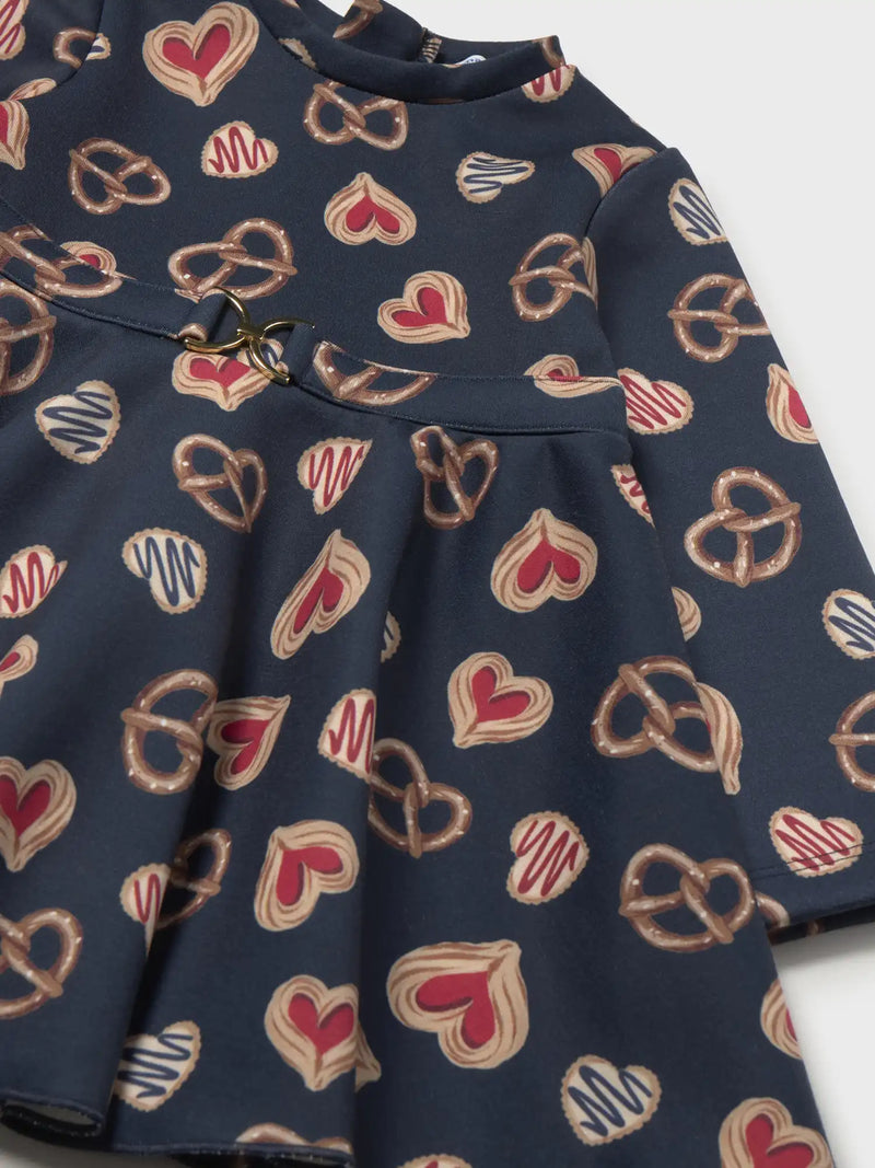 Mayoral navy dress with all over print of pretzels and sweet pastries.