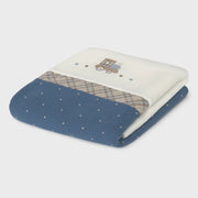 Closer look at the Mayoral patterned blanket showing detail of the embroidered train design.