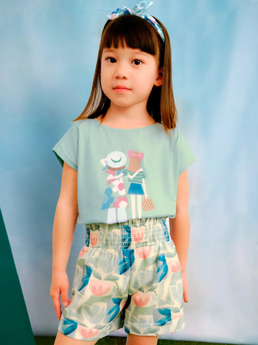 Girl modelling the Mayoral patterned shorts set.