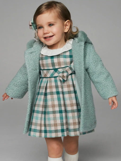 Baby girl wearing the Mayoral plaid dress.