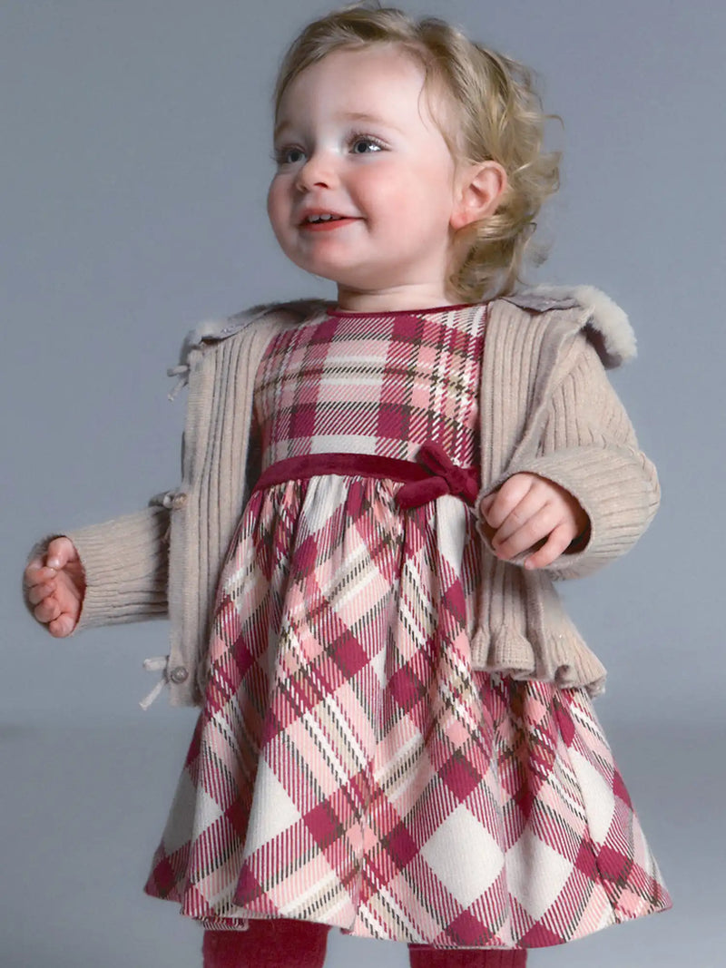 Baby girl modelling the Mayoral plaid dress.