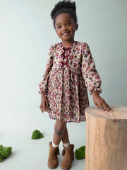 Girl wearing the Mayoral pleated dress.