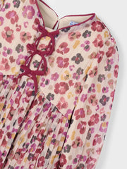 Closer look at the Mayoral pleated dress showing detail of the orange and pink floral pattern