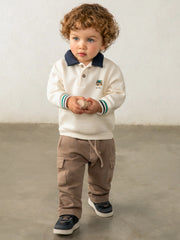 Baby boy modelling the Mayoral polo sweatshirt.