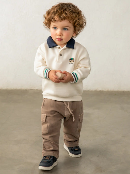 Baby boy modelling the Mayoral polo sweatshirt.