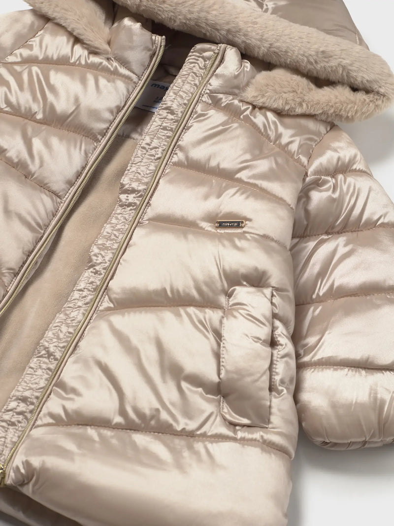 Closer look at the Mayoral puffer jacket showing detail of the gold logo badge.