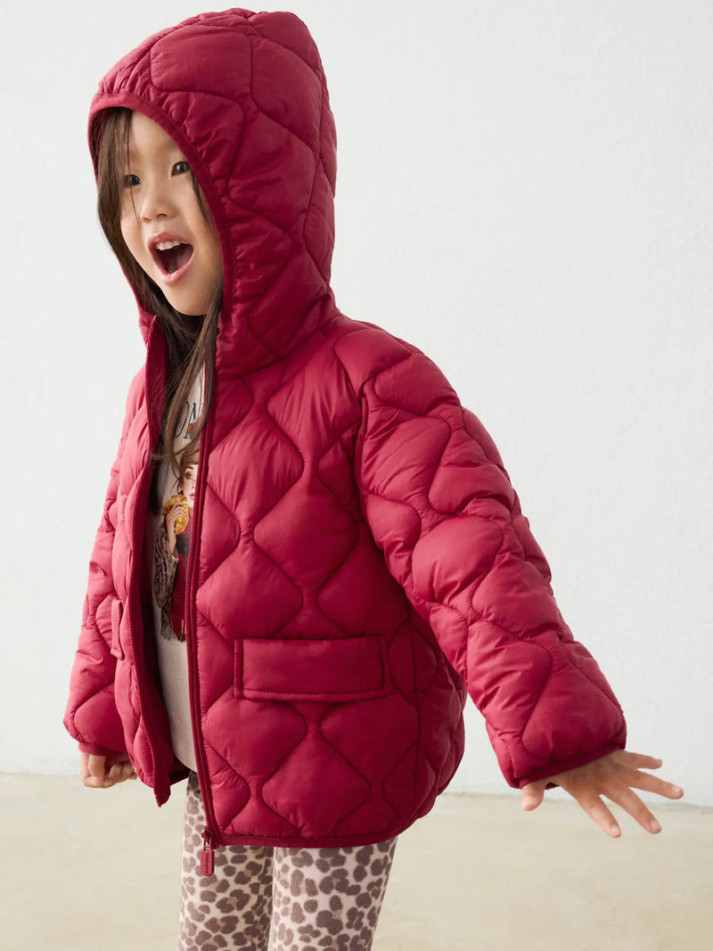 Girl in red quilted coat by Mayoral.