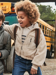 Girl modelling the Mayoral reversible fleece jacket.