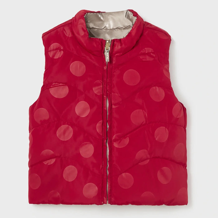 Baby girl's gilet with red polka dot pattern.