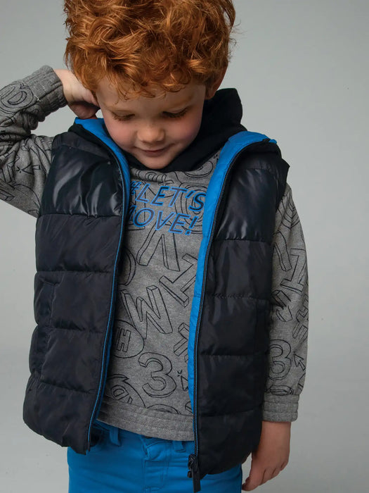 Boy wearing the Mayoral reversible gilet.