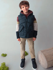 Boy modelling the Mayoral reversible gilet.