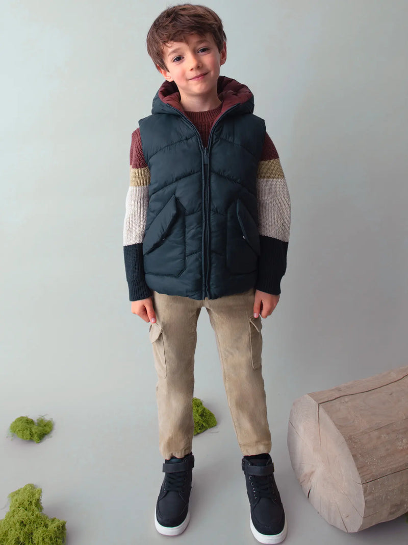 Boy modelling the Mayoral reversible gilet.